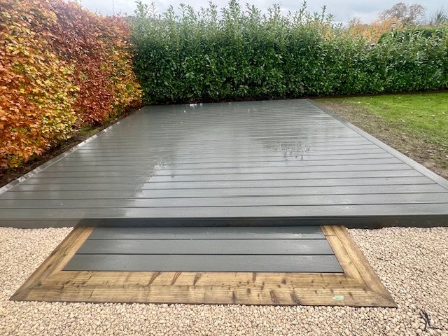Grey solid wood composite deck with step